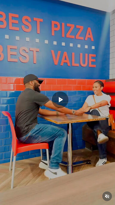 Customers enjoying Roman's Pizza at a restaurant