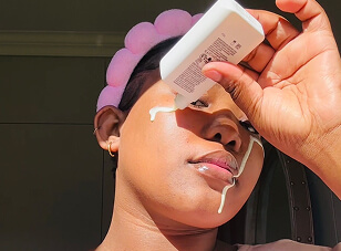 Creator applying skincare product for Q4 campaign content review