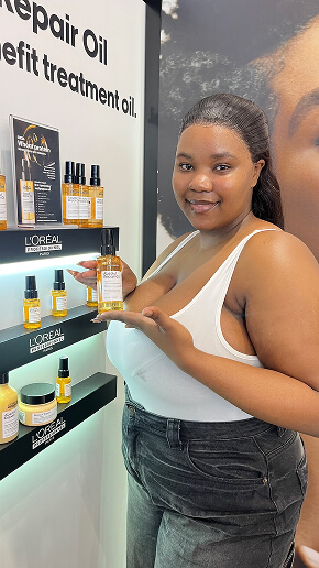Nano influencer presenting L'Oréal Elvive haircare products in a retail aisle