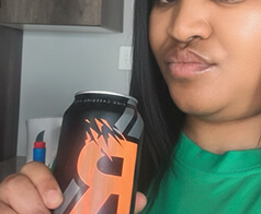 Creator holding a Rockstar energy drink can