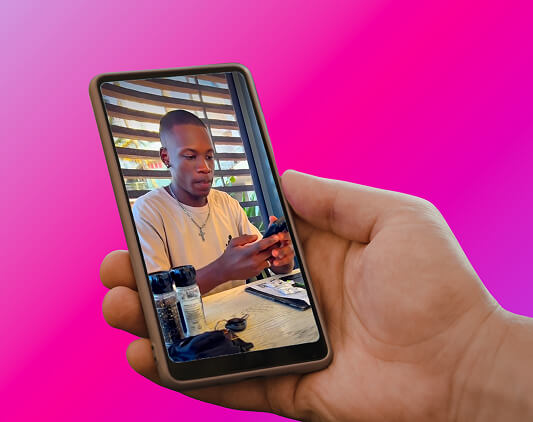 Hand holding a phone showing a customer using the bank app