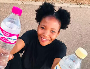 Customer holding flavoured water bottles