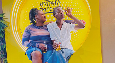 Consumers with product in front of Umtata Kitchen backdrop