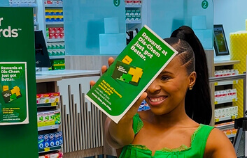 Customer holding Dis-Chem rewards brochure in store