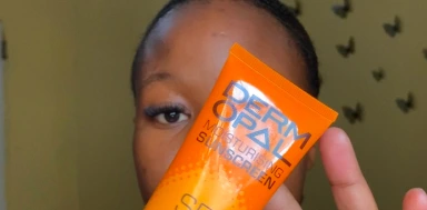 Person holding Derm Opal sunscreen