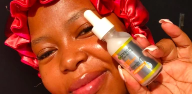 Person holding a skincare serum