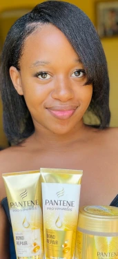 Woman holding Pantene Pro-V Bond Repair hair care products