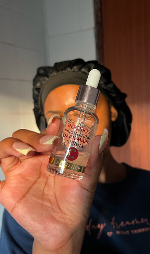 Creator holding skincare serum